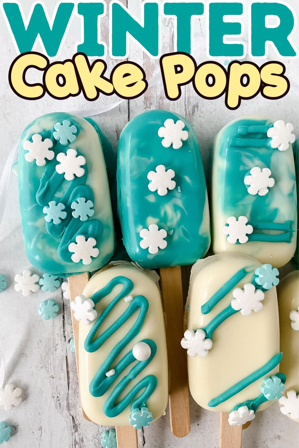 Cake pops covered with white and blue candy melts topped with snowflake sprinkles.