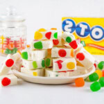 A plate of white nougat with colorful candy pieces.
