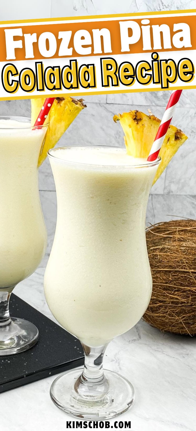 Two glasses of frozen piña colada with pineapple slices and striped straws, beside a whole coconut, on a textured surface.