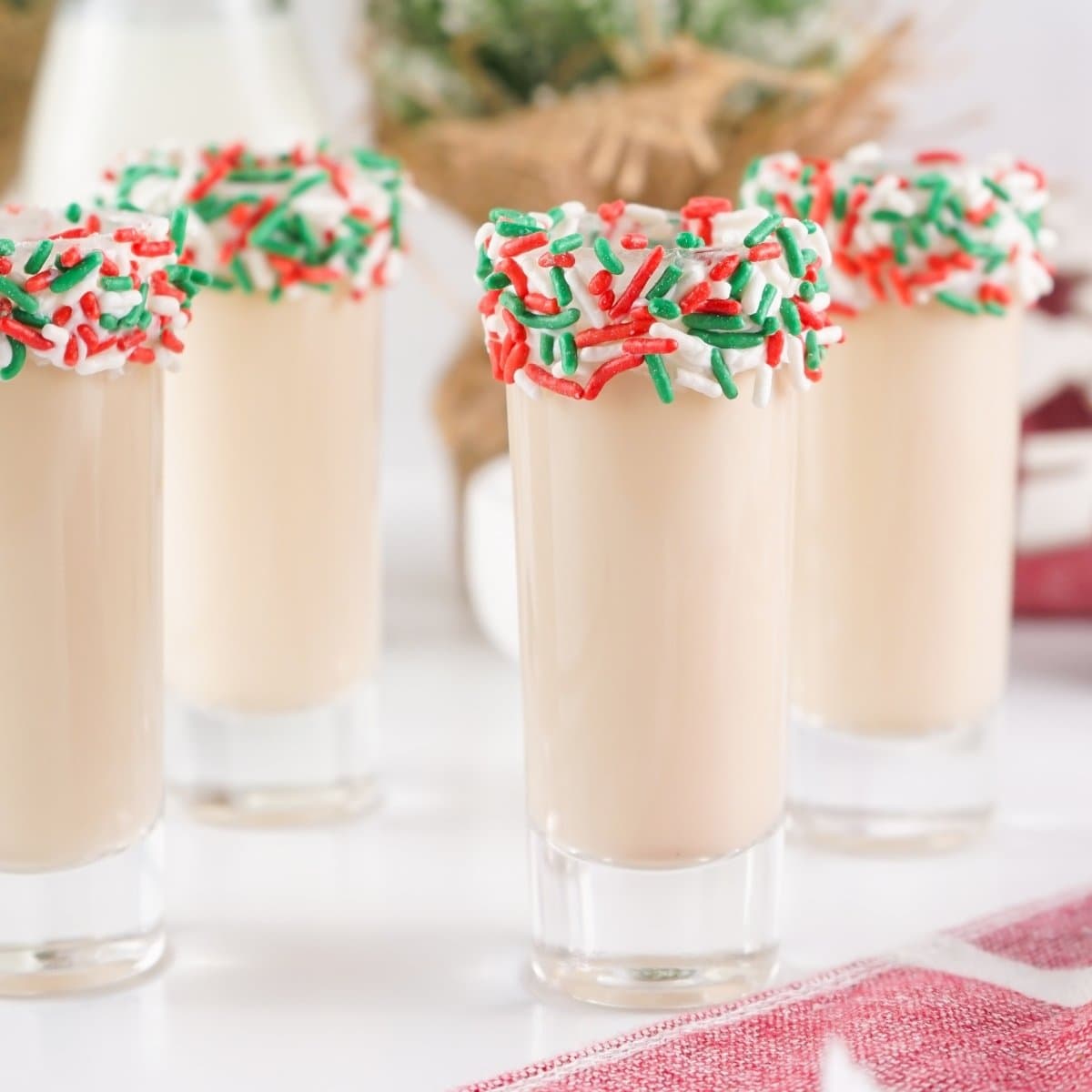 Sugar Cookie drinks with red and green sprinkles on glass rims.