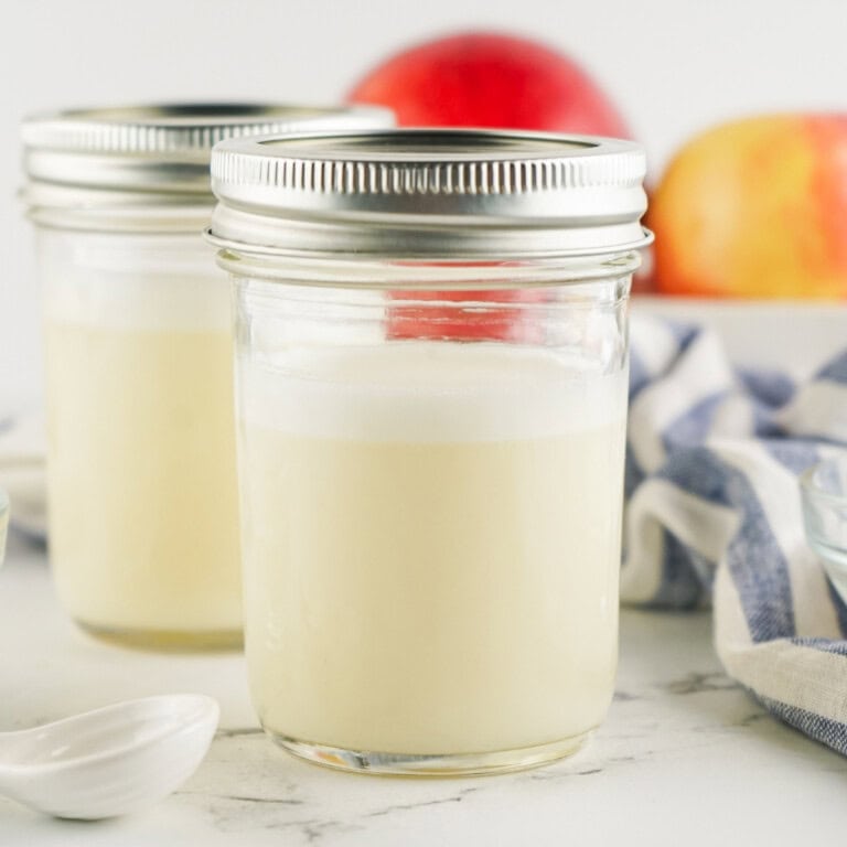 Two glass jars of sweetened condensed milk.