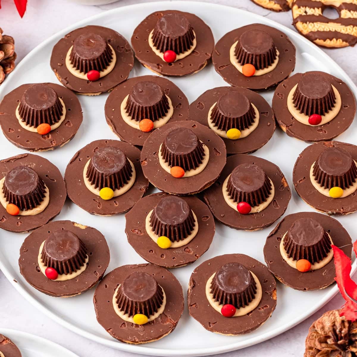 A plate of chocolate pilgrim hat-shaped cookies.