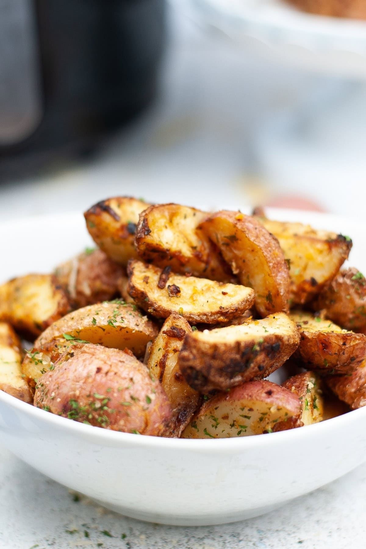 A bowl of seasoned roasted potatoes.