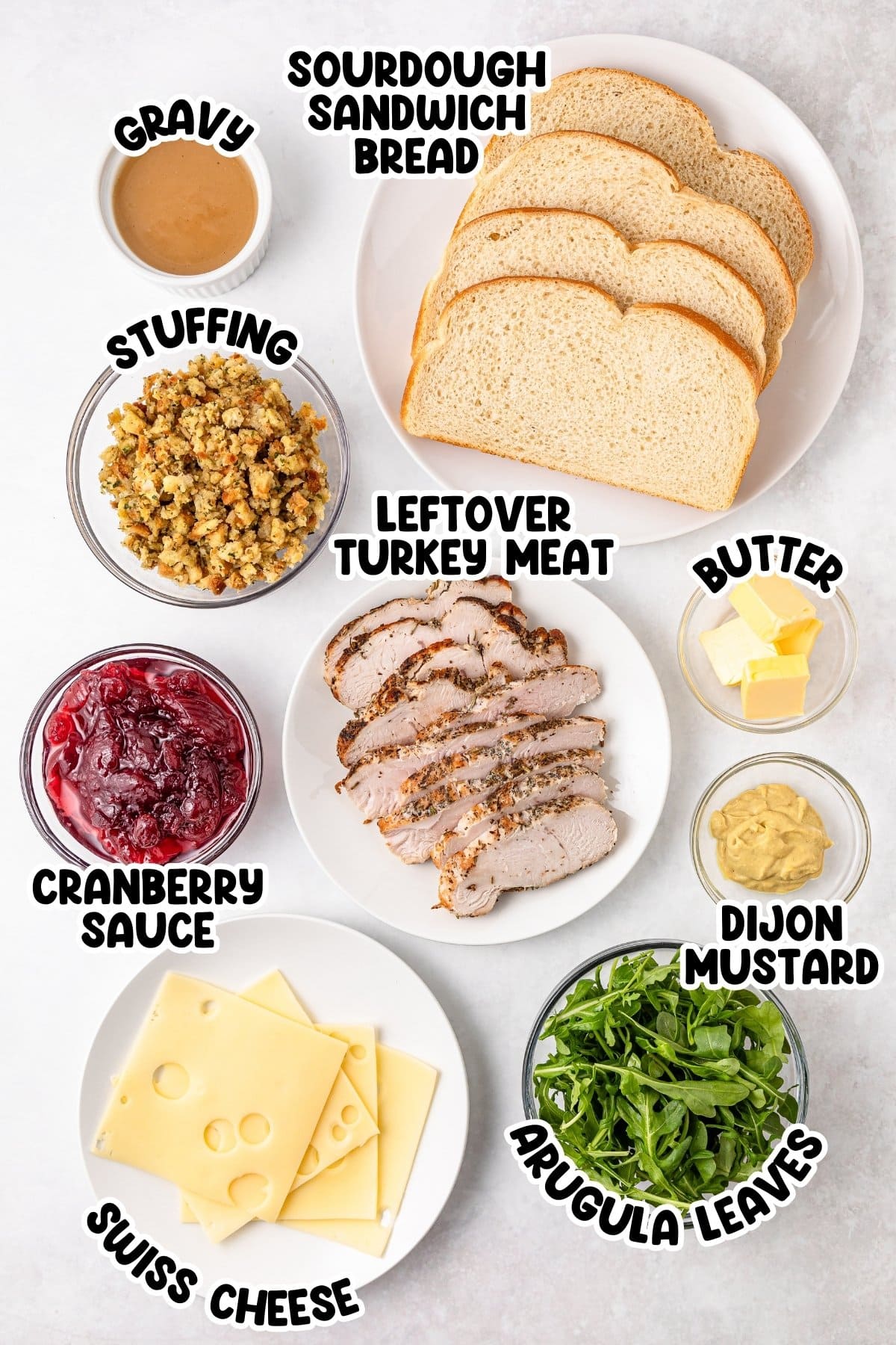 Ingredients for a turkey sandwich with bread, meat, cheese, and condiments.