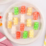 A plate of colorful frozen gummy bears arranged neatly.
