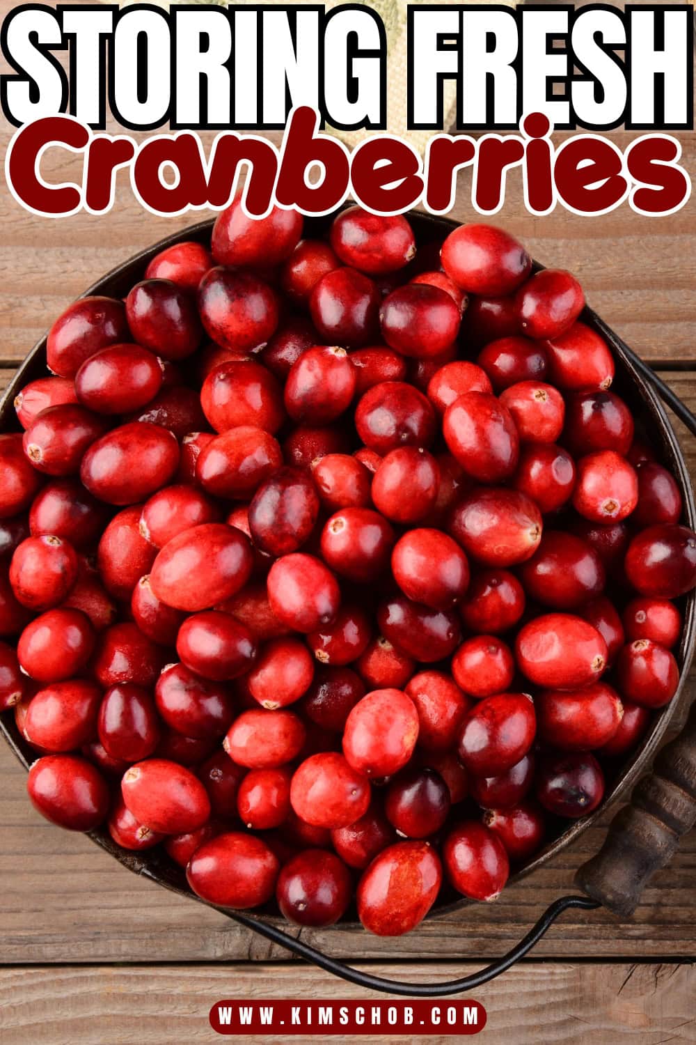 A basket of fresh cranberries on a wooden table.