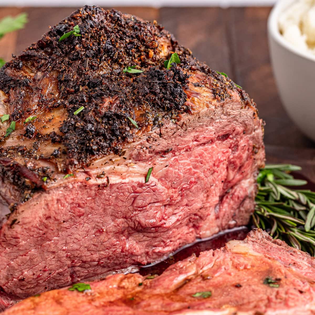 Sliced roast beef with herbs.