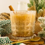Eggnog cocktail drink with a cinnamon stick garnish.