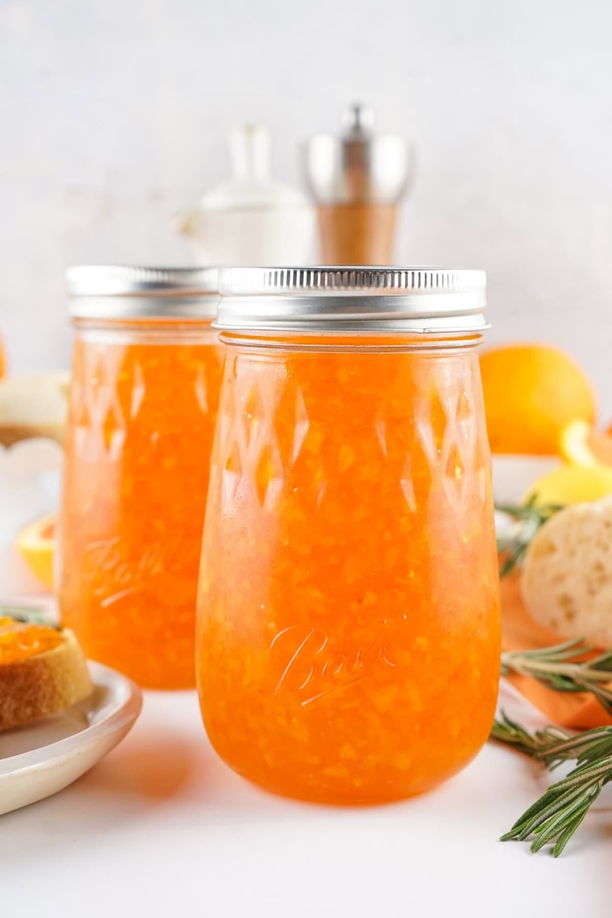 Two jars of orange marmalade.