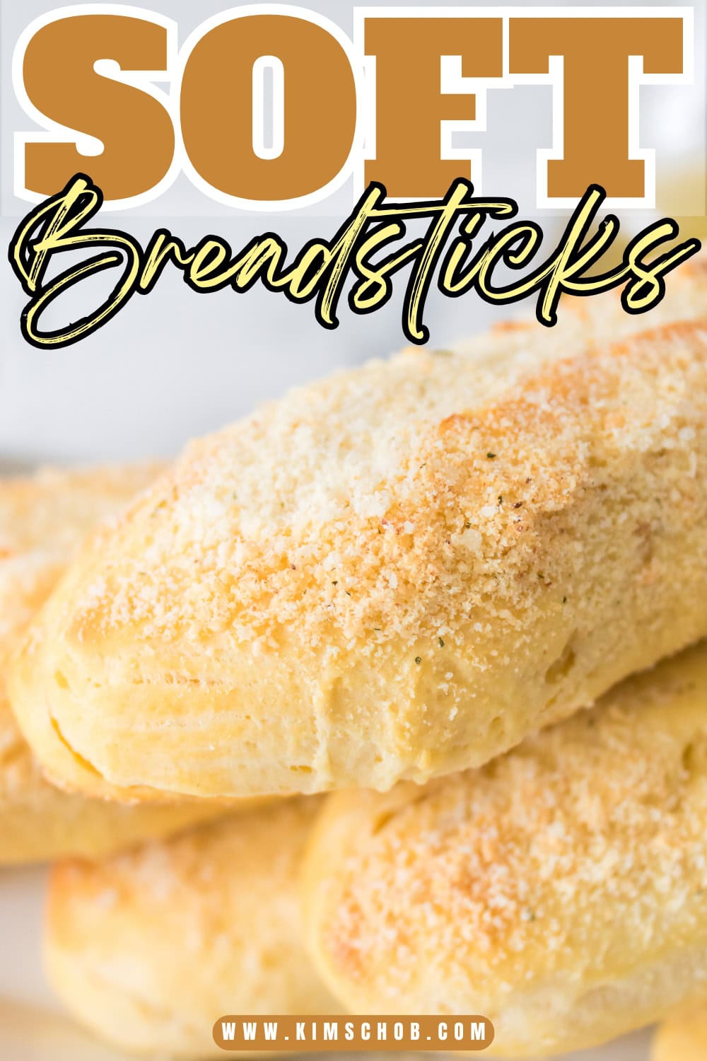 Freshly baked soft breadsticks with cheese on top.