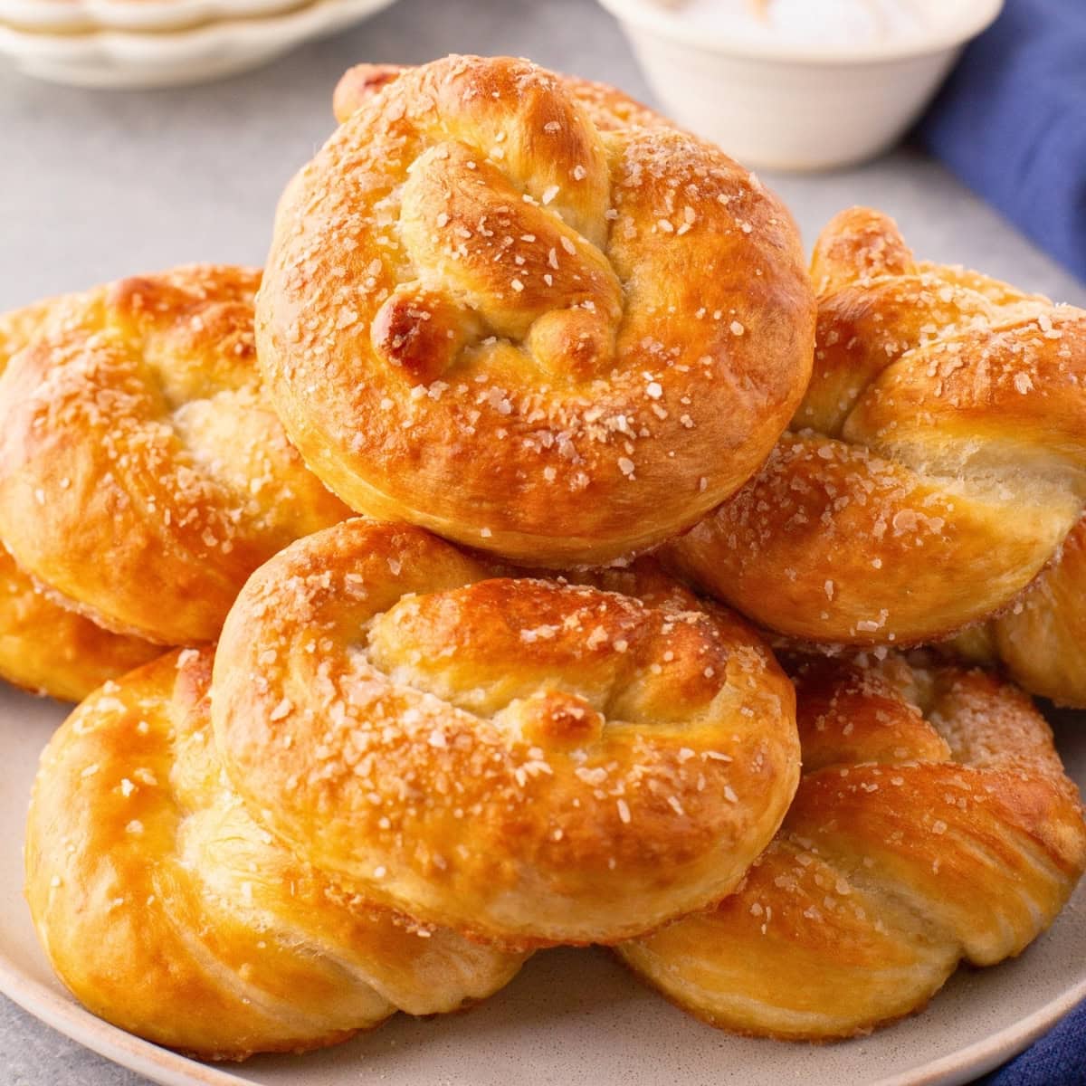 A plate of freshly baked pretzels topped with coarse salt.