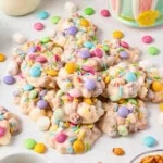 Colorful, sprinkled candies with marshmallows on a white surface.