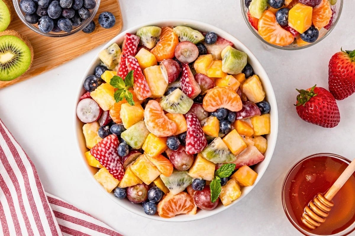 A bowl of colorful mixed fruit salad with berries, grapes, and kiwi.