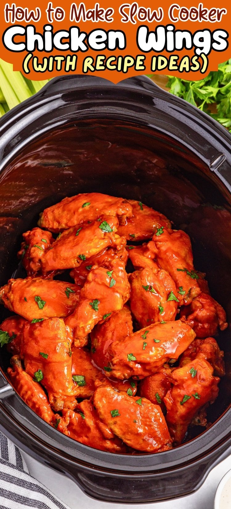 Chicken wings in a slow cooker, coated in sauce and garnished with herbs.
