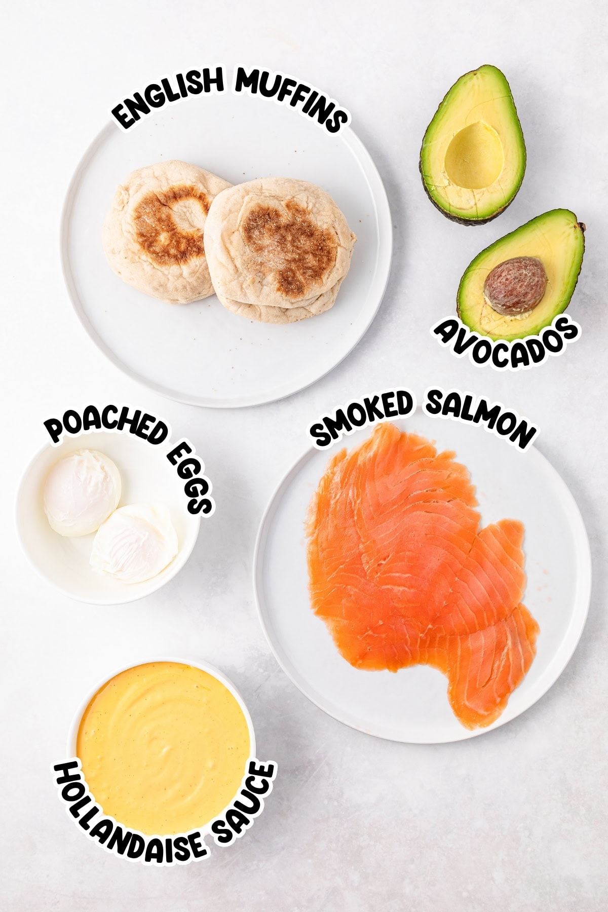 Plates of English muffins, avocados, poached eggs, smoked salmon, hollandaise sauce.