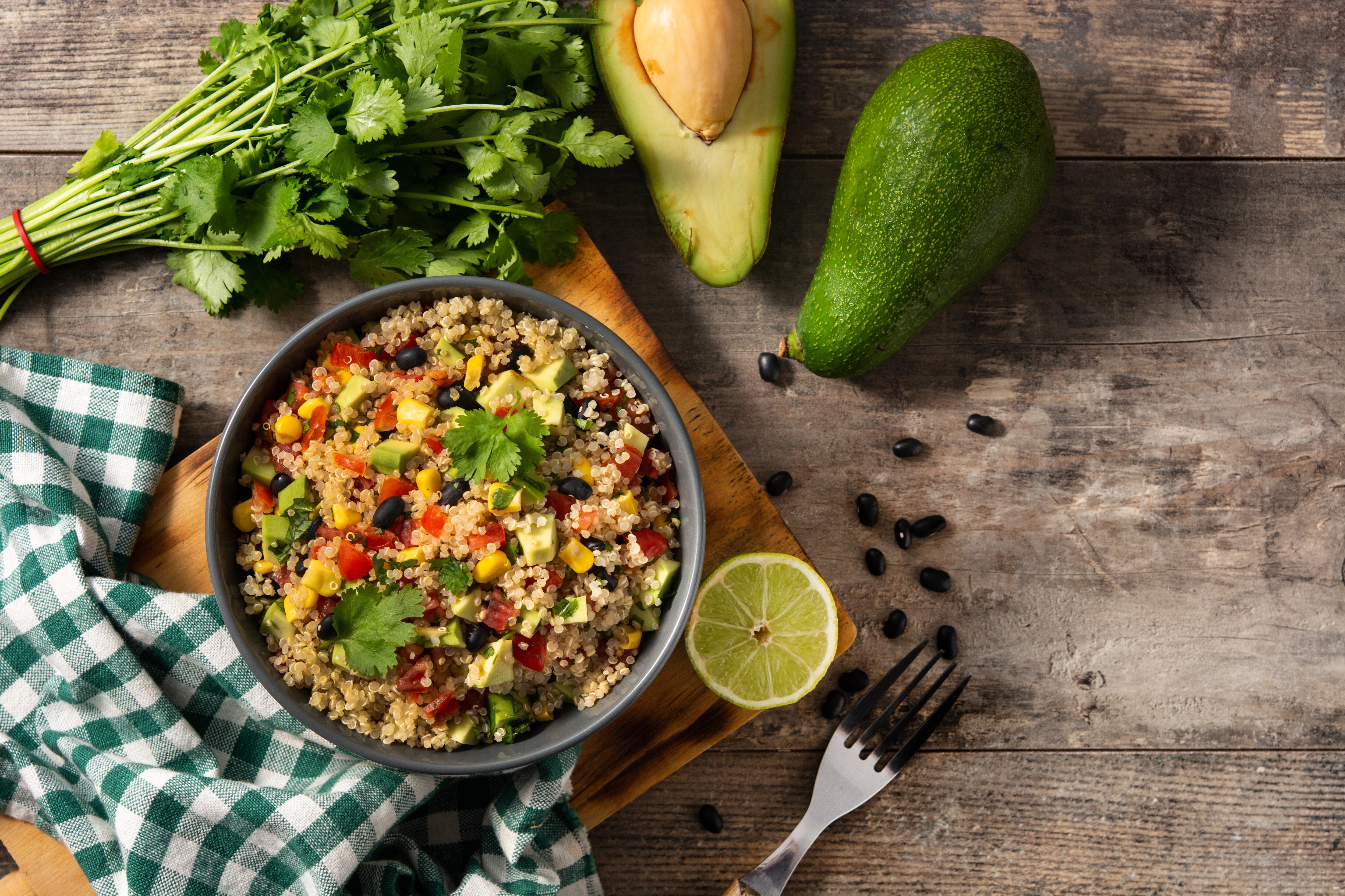 A quinoa bowl inspired by Mexican salad recipes with avocado, beans, and corn.