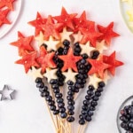 Watermelon skewers and blueberries arranged like a star-shaped fruit bouquet.