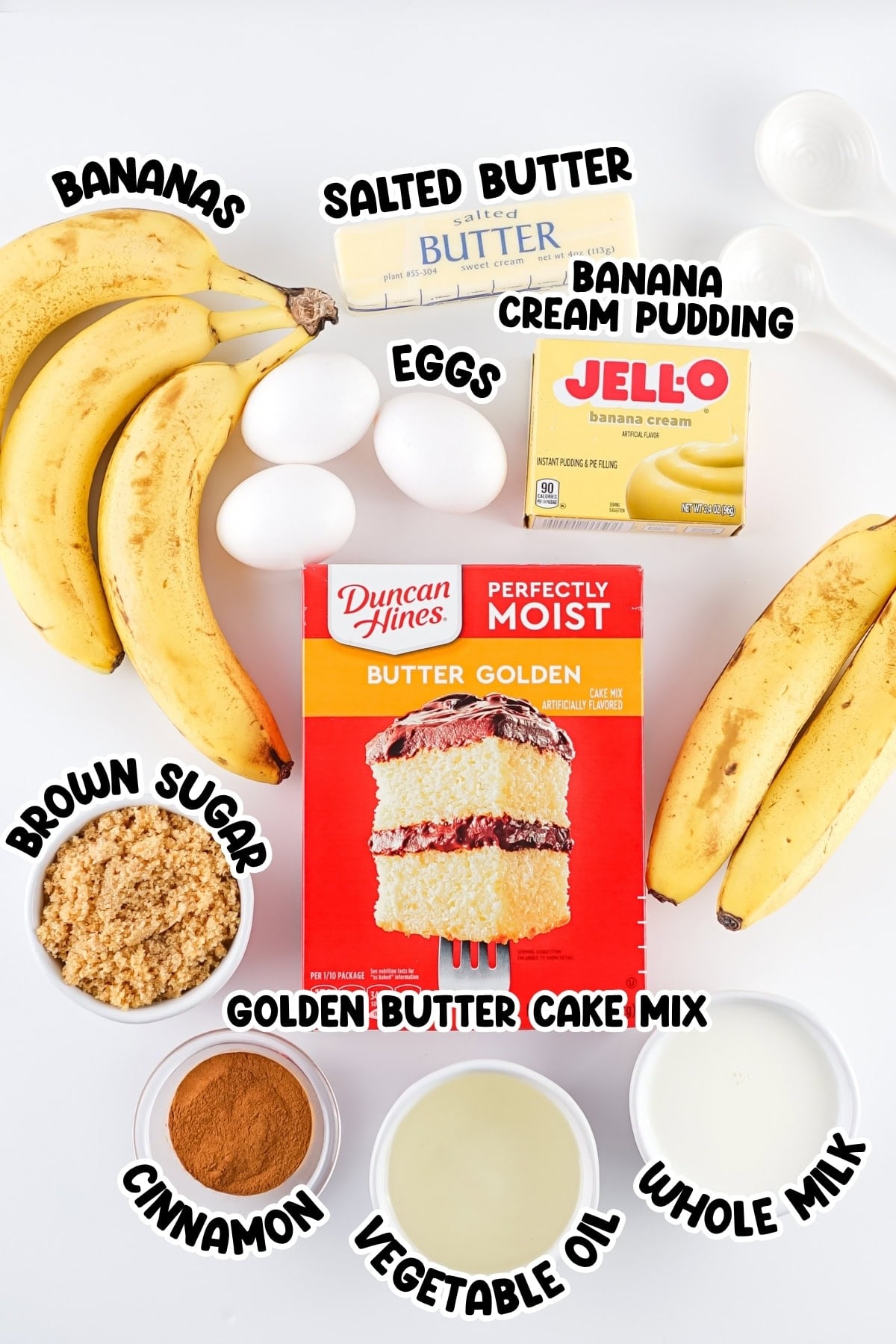Baking ingredients for banana cake, including bananas, eggs, cake mix, and more.