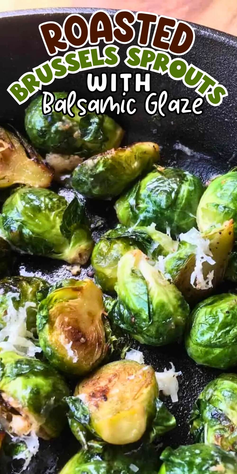 Roasted Brussels sprouts with balsamic glaze and grated cheese in a skillet.