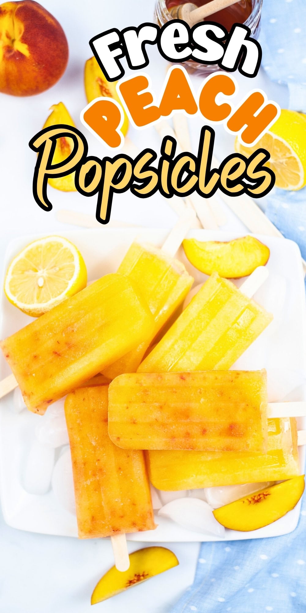 A plate of peach popsicles with lemon and peach slices on the side.