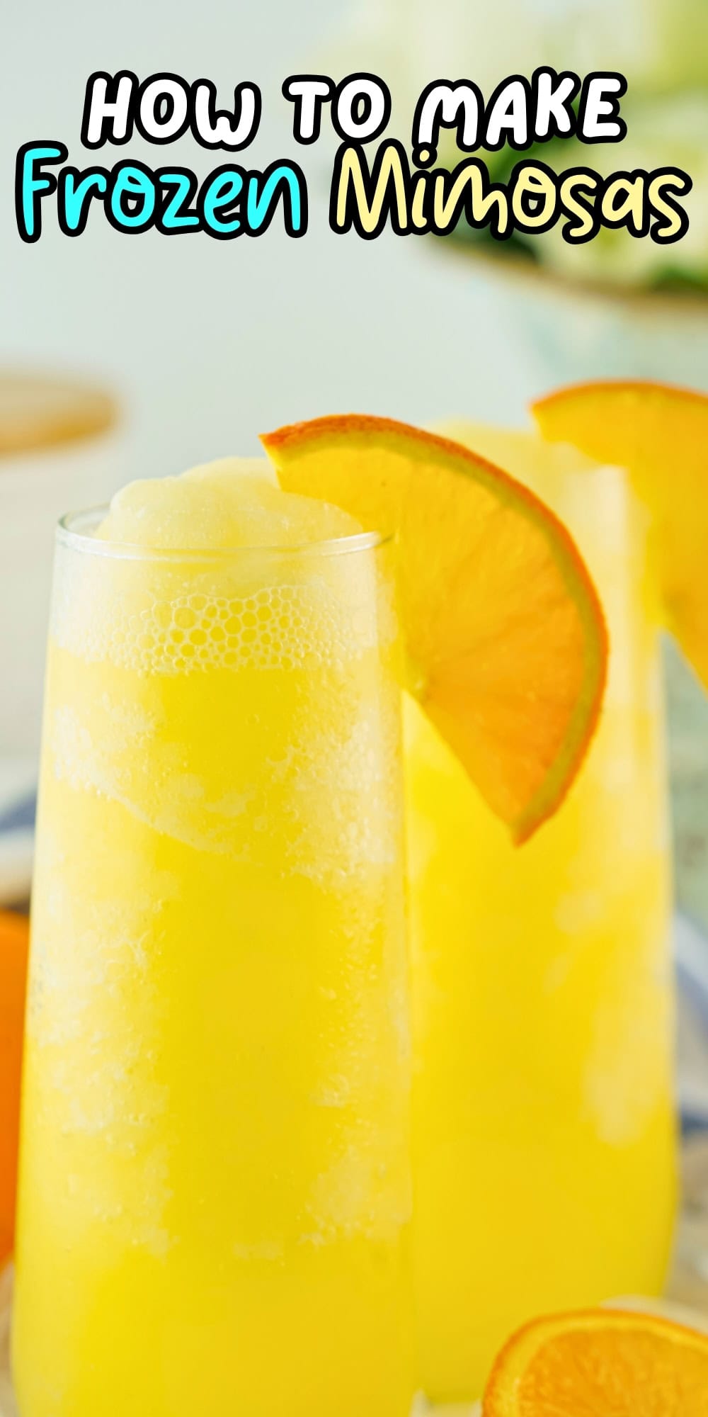 Two frosty mimosas with orange slices.