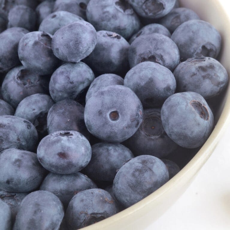 A bowl filled with fresh, ripe blueberries.