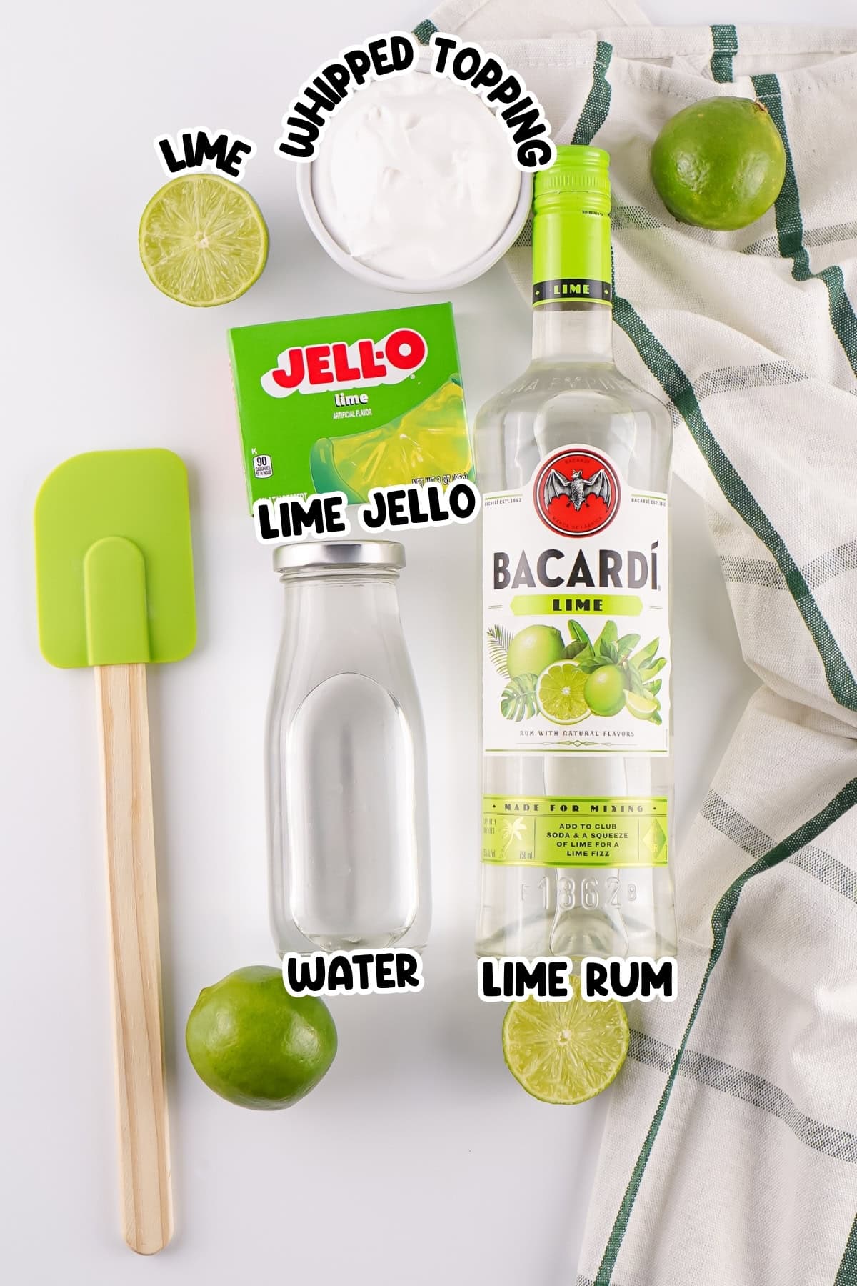 Lime jello, lime rum, lime, whipped topping, water, spatula, and towel.