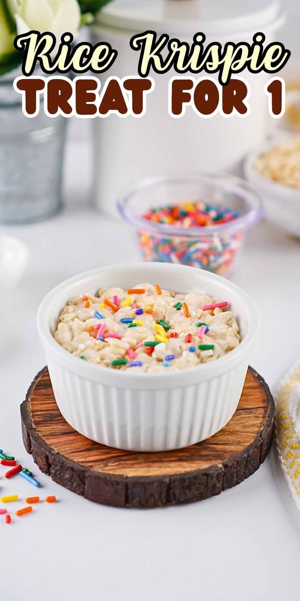 Single Rice Krispie treat in a white ramekin topped with colorful sprinkles.
