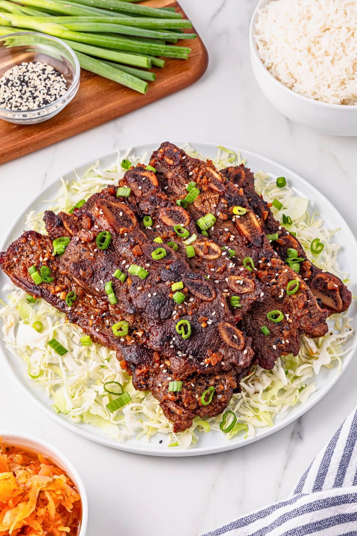 Grilled Korean short ribs on shredded cabbage, topped with sliced green onions.