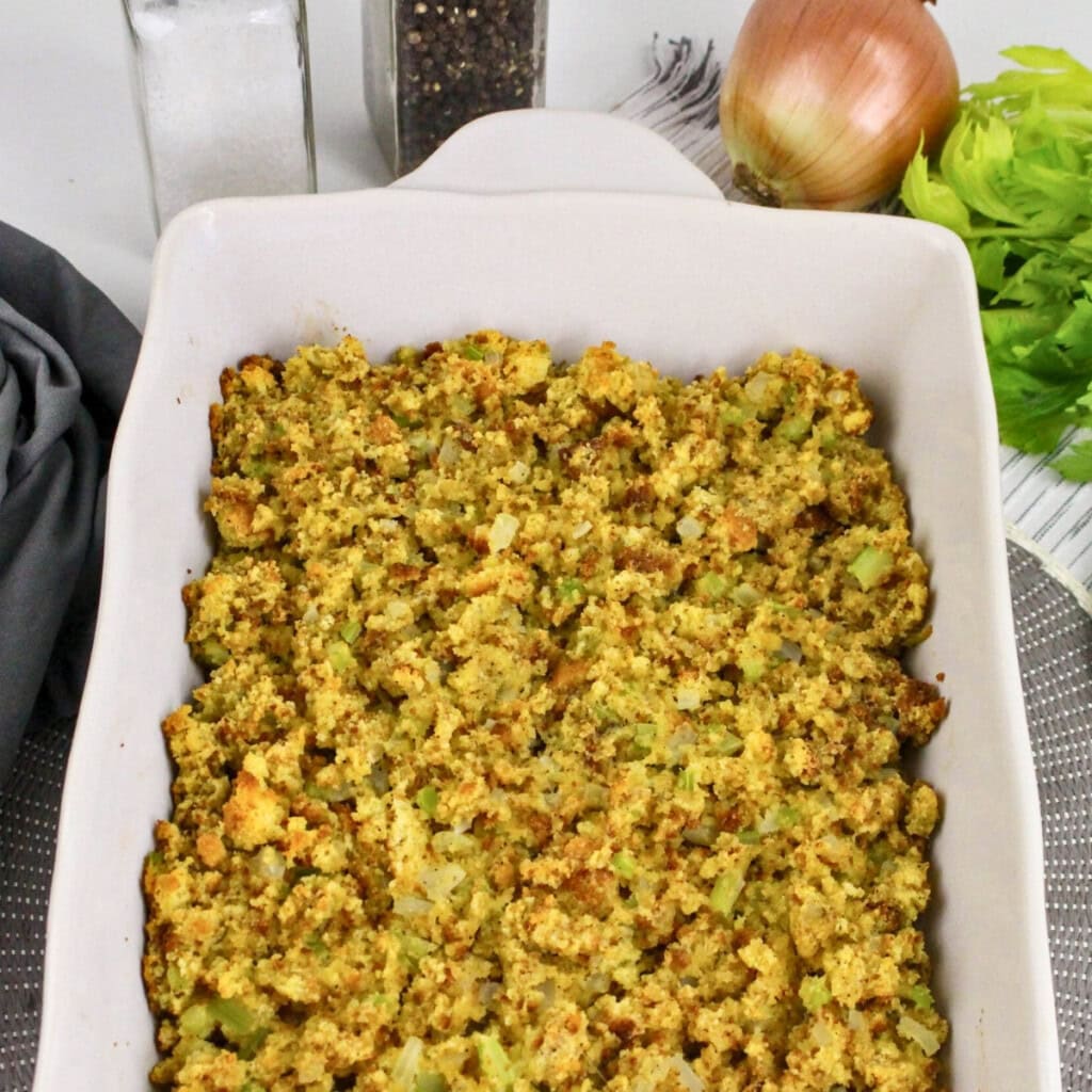 A baking dish of cornbread stuffing&mdash;perfect for dishes for Friendsgiving.