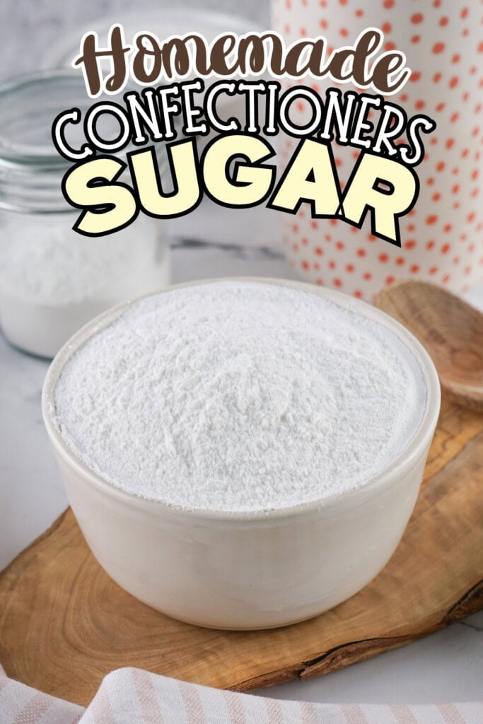 A bowl of confectioners sugar on a wooden board.