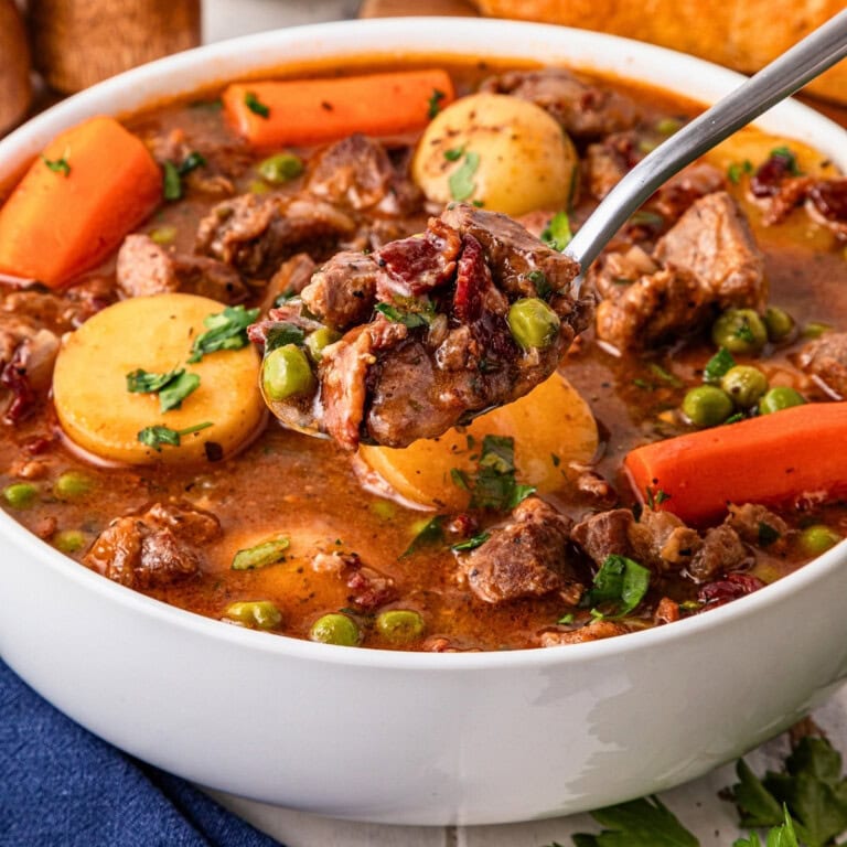 A spoonful of hearty beef stew perfect for cozy fall soup recipes.