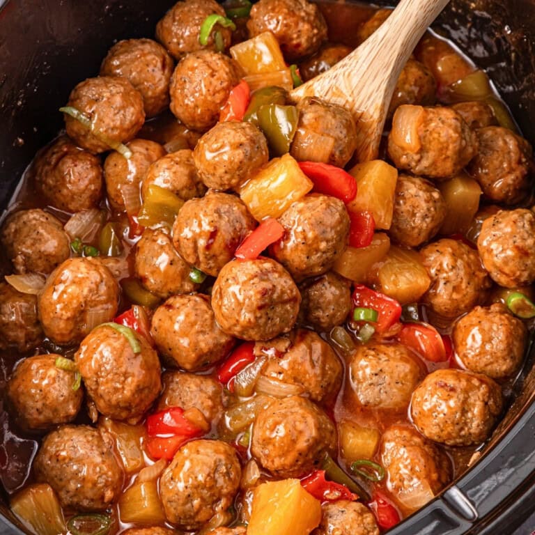 Meatballs with peppers, onions, and pineapple in a sweet sauce—perfect for Crockpot Halloween recipes.