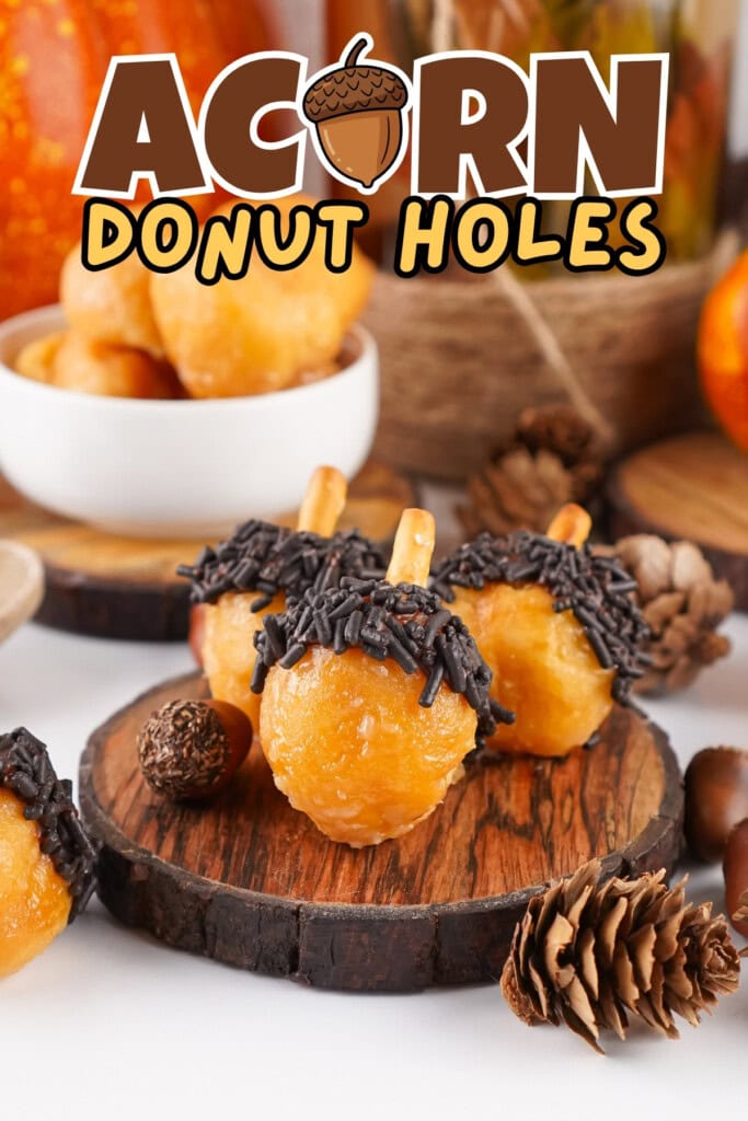 Three acorn-shaped donut holes with chocolate and pretzel sticks on wooden boards.