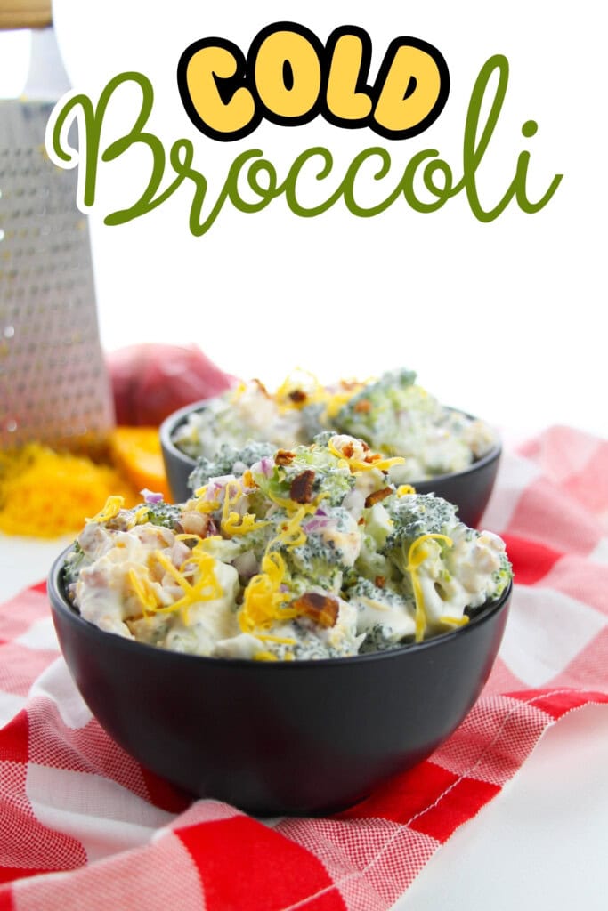 Two bowls of cold broccoli salad with cheese and bacon on a red checkered cloth.