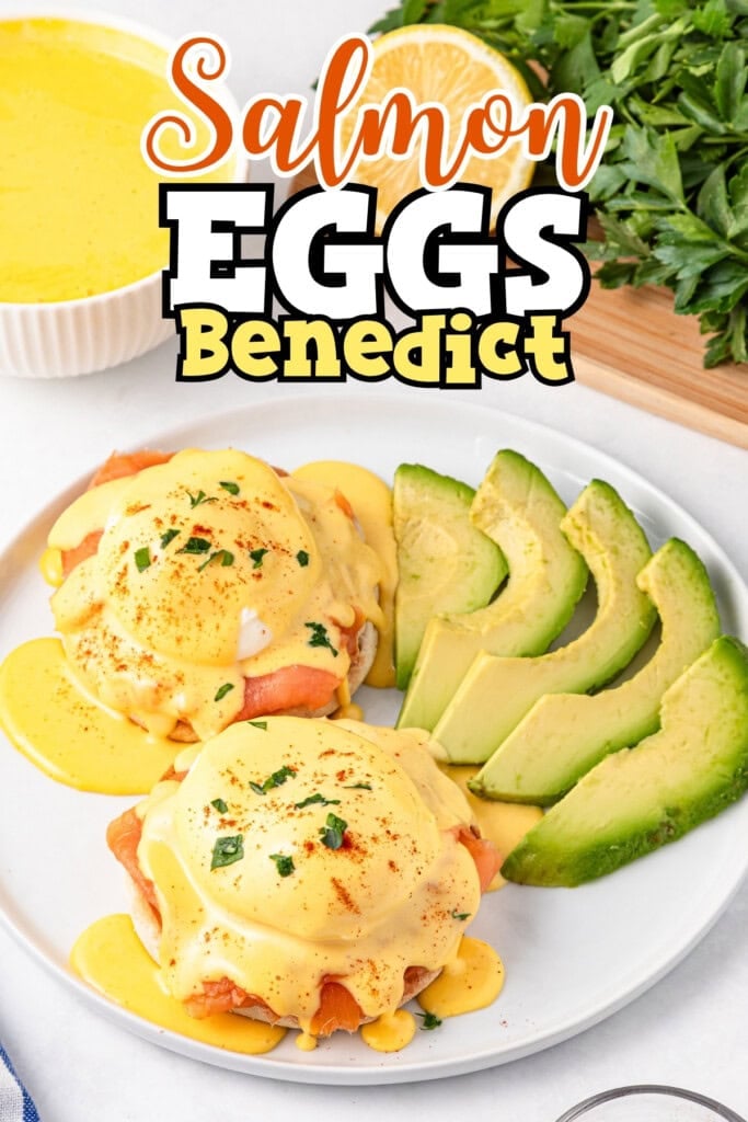Salmon eggs benedict with avocado slices on a white plate, topped with sauce.
