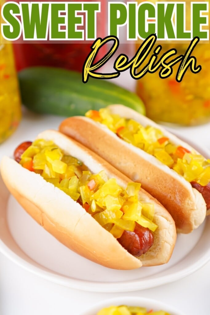 Two hot dogs topped with sweet pickle relish on a white plate.