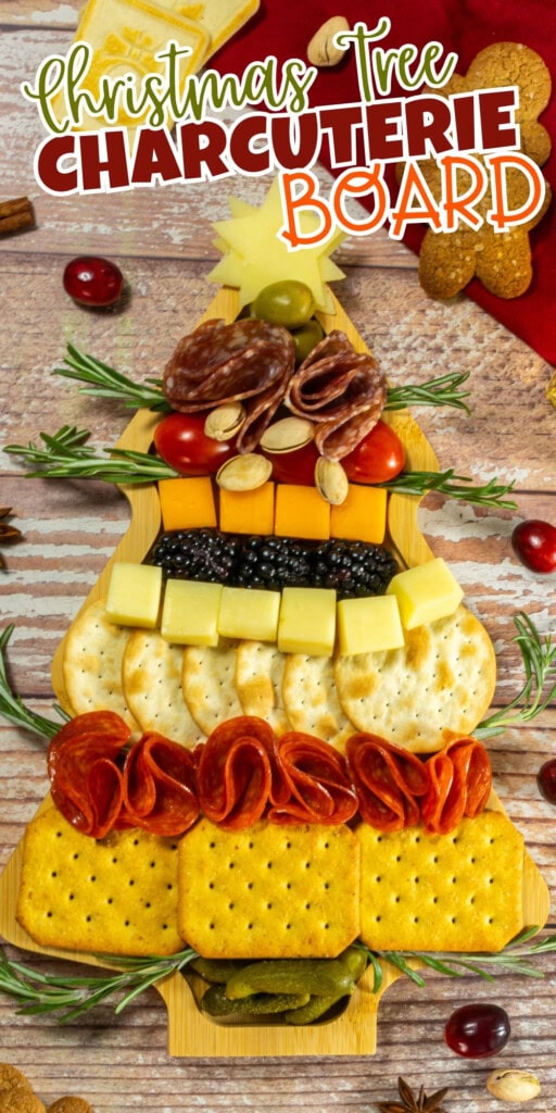 A Christmas tree-shaped charcuterie board with crackers, cheese, and meats.