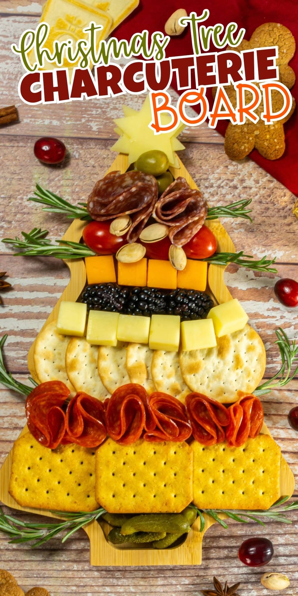 A Christmas tree-shaped charcuterie board with crackers, cheese, and meats.