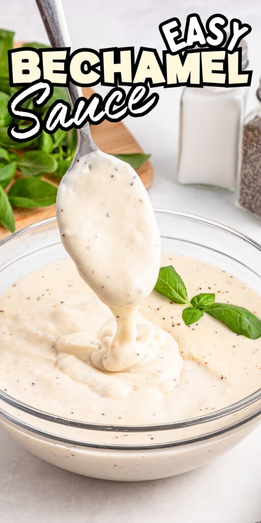 A spoon lifts creamy béchamel sauce from a glass bowl, with basil garnish.