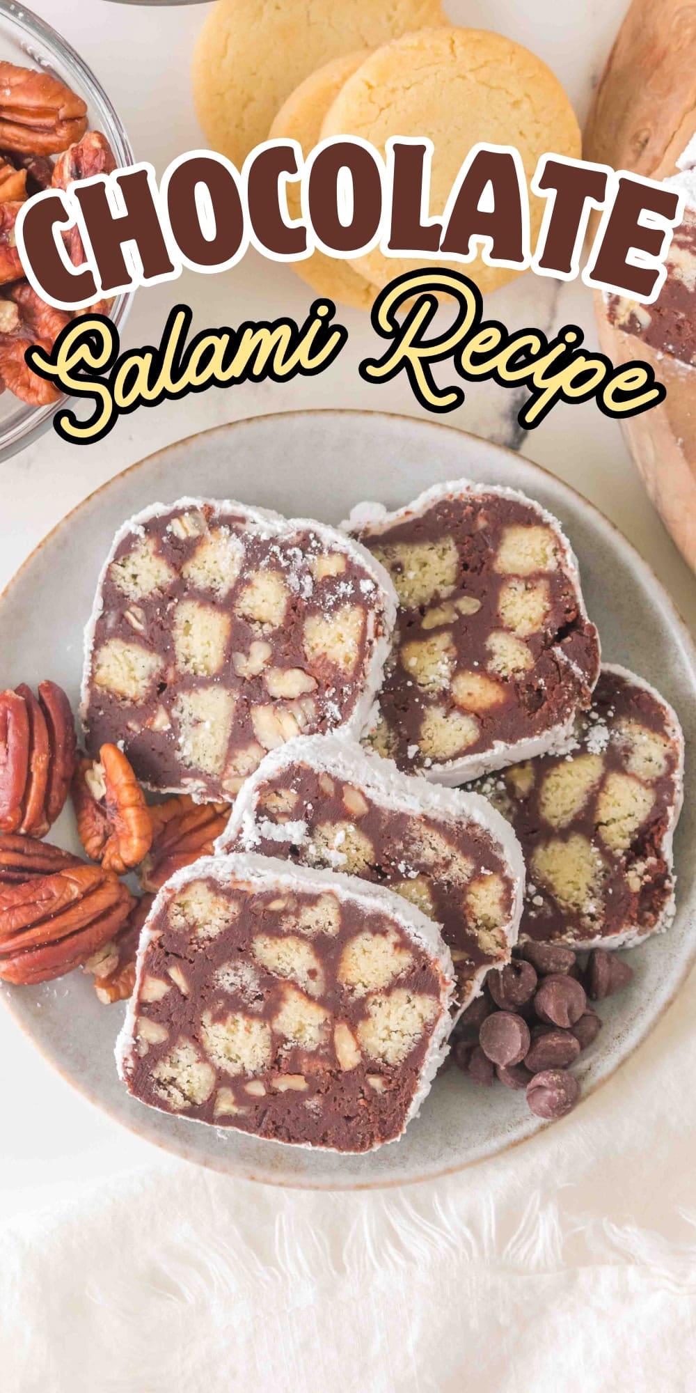 Plate of chocolate salami slices with pecans and chocolate chips.