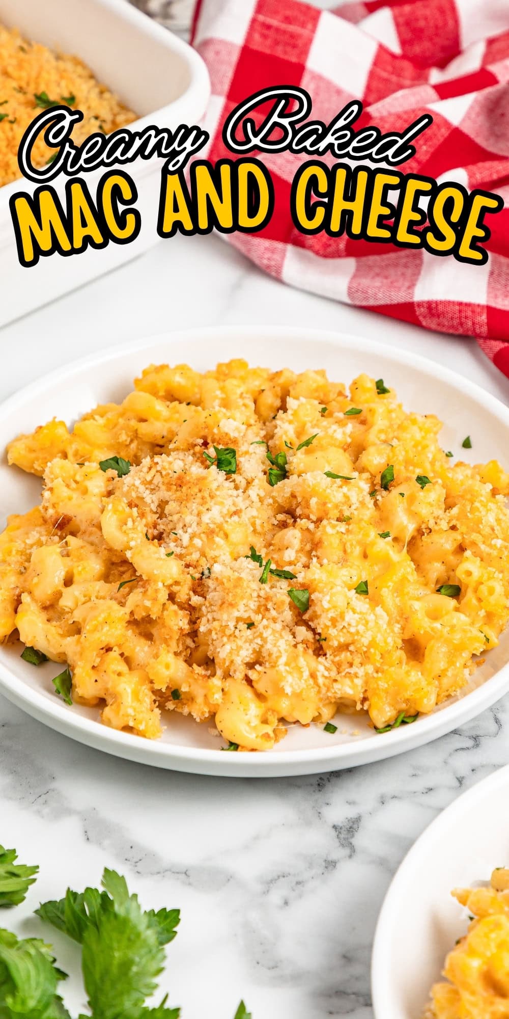 Plate of creamy baked mac and cheese topped with breadcrumbs and parsley.