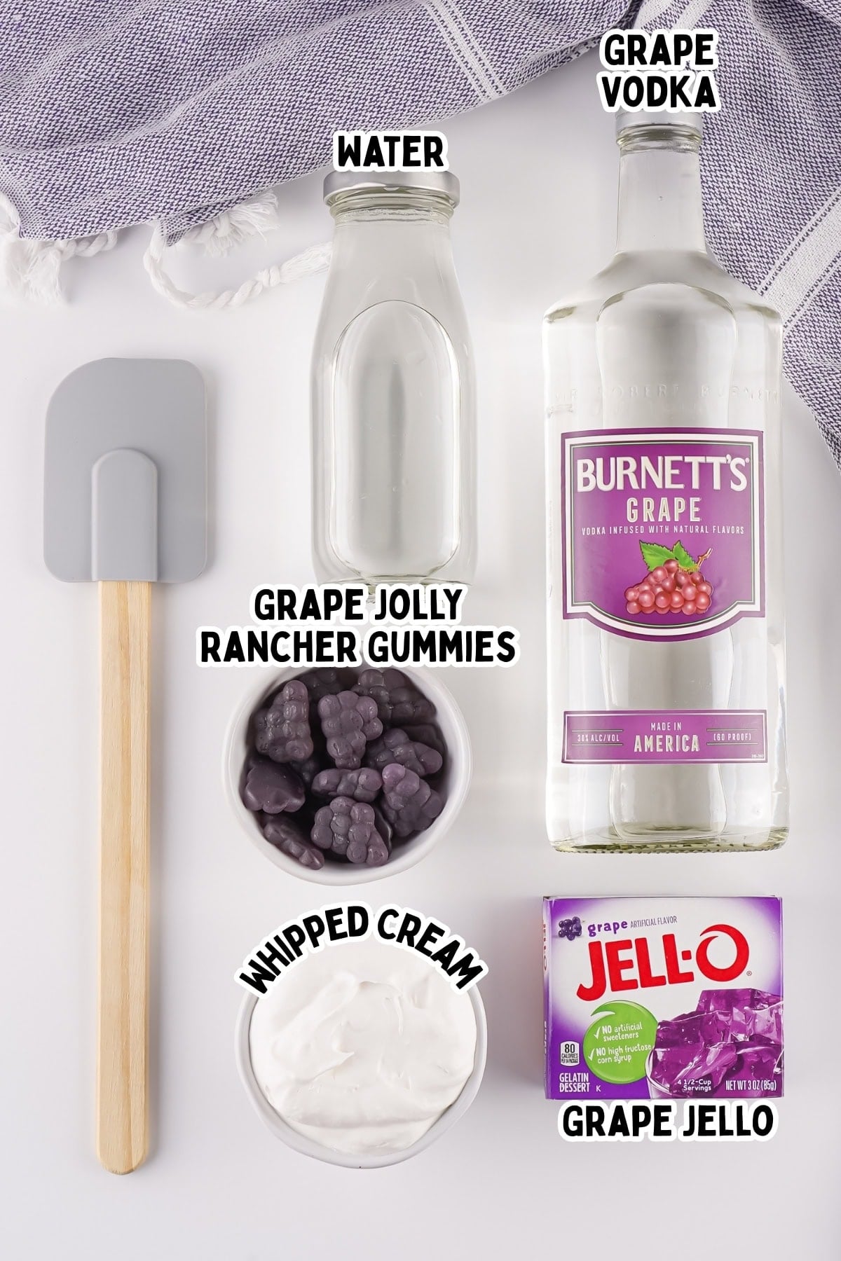 Ingredients for grape Jello shots: spatula, water, grape vodka, gummies, cream, Jello.