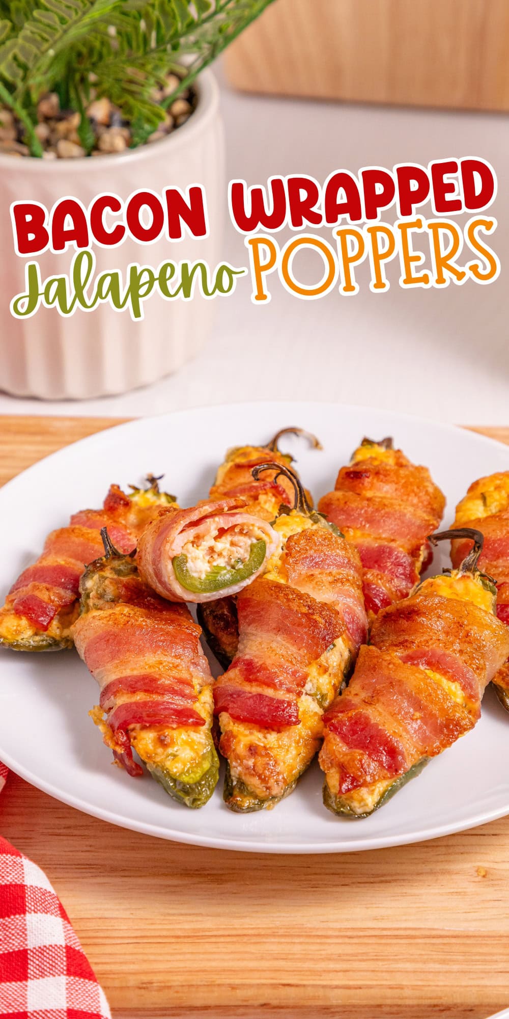 Bacon-wrapped jalape&ntilde;o poppers served on a white plate with a plant in background.
