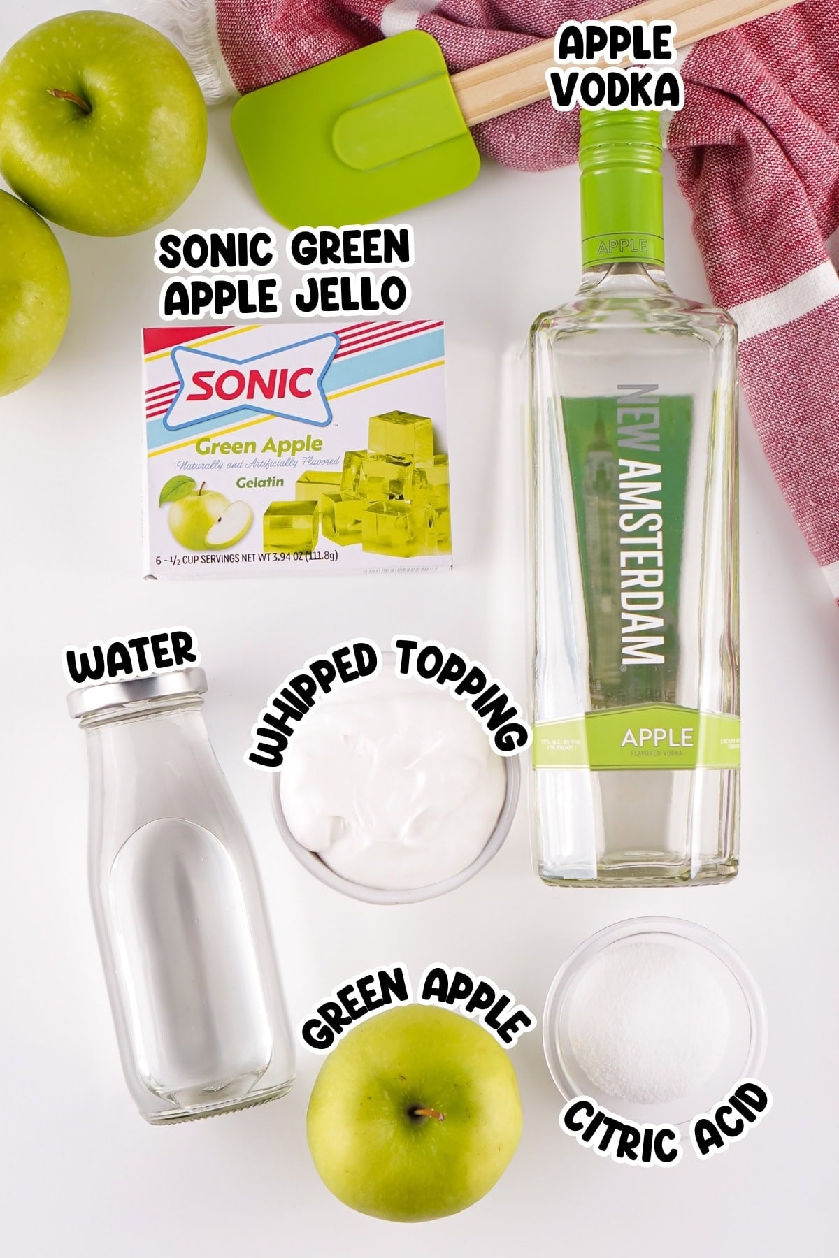Ingredients for green apple jello shots with labels, including vodka and jello mix.