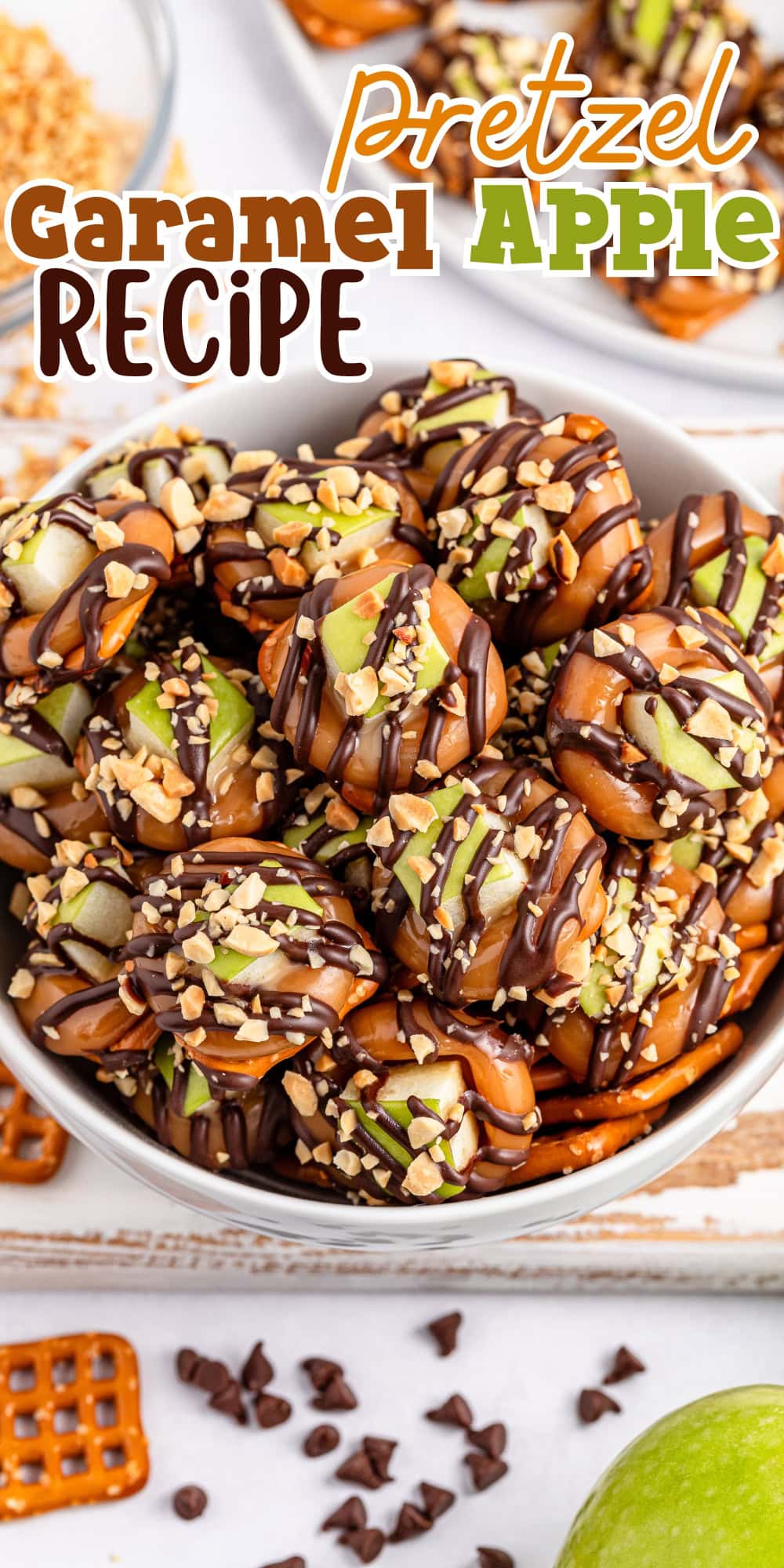A bowl of pretzel caramel apple bites drizzled with chocolate and chopped nuts.