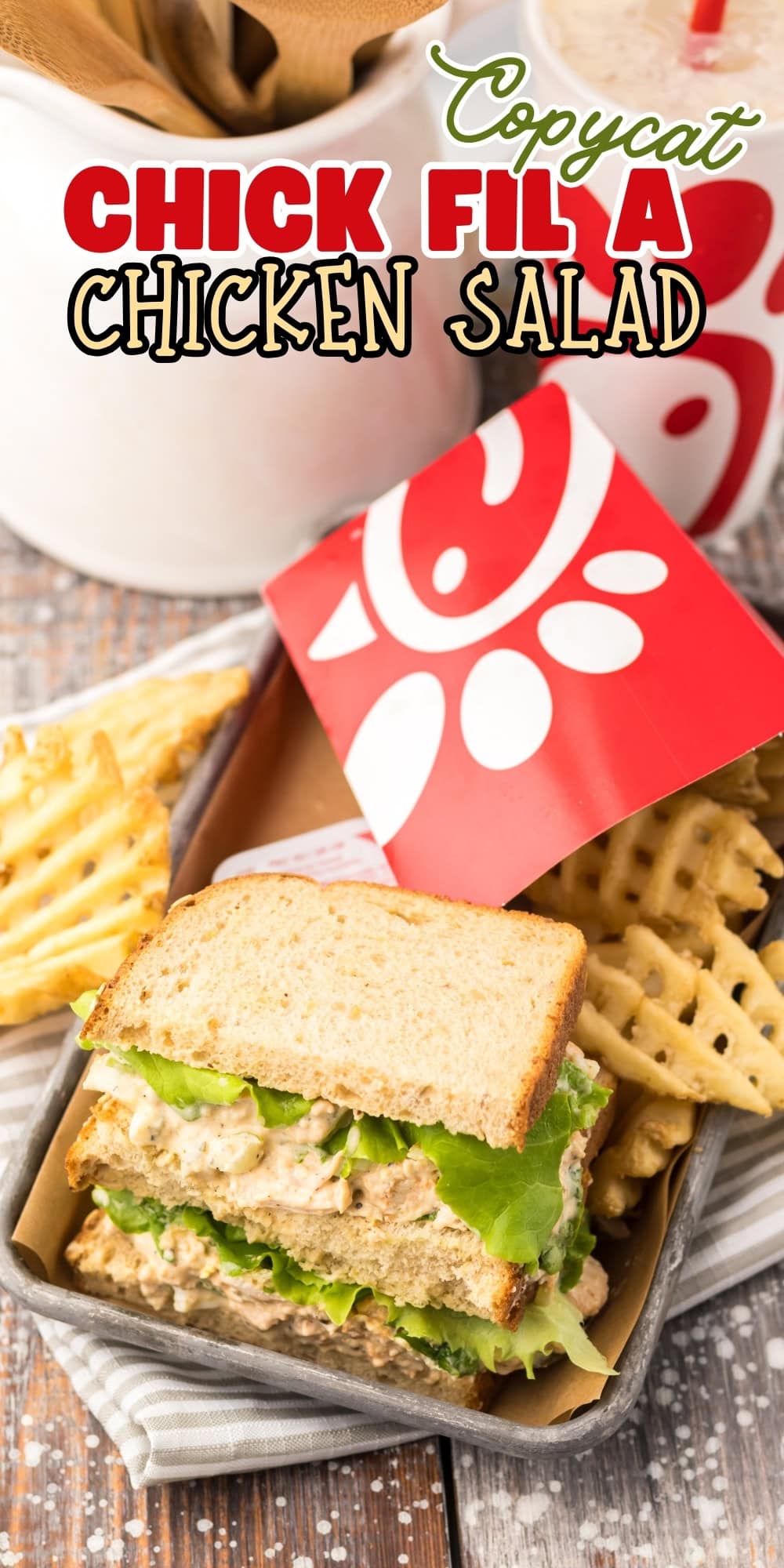 Copycat Chick-fil-A chicken salad sandwich with waffle fries on a wooden table.