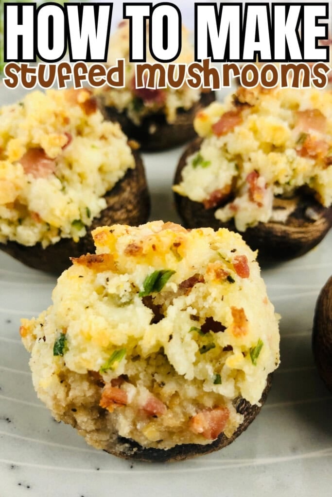 Stuffed mushrooms topped with crispy breadcrumbs on a white plate.