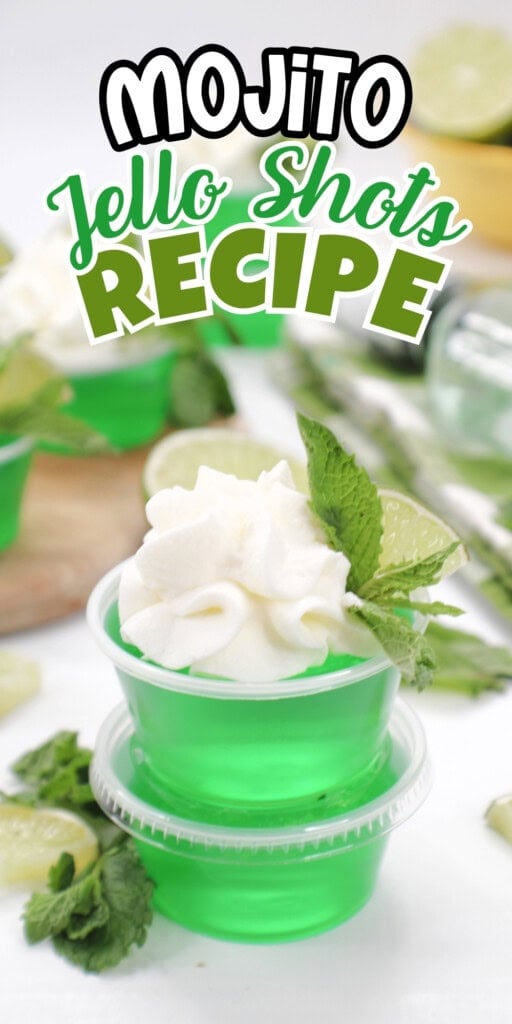 Green mojito jello shot in a cup, topped with whipped cream and mint garnish.