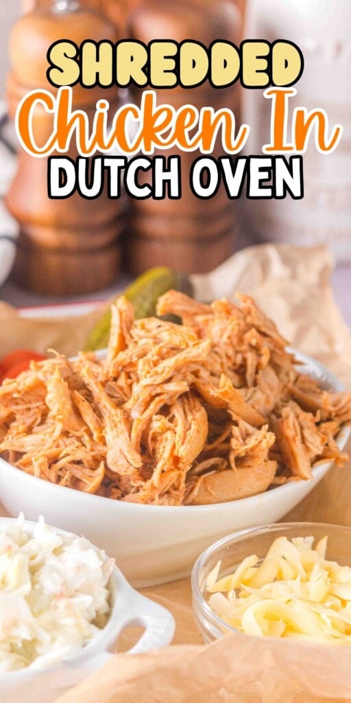 A bowl of shredded chicken with cheese and coleslaw in small dishes nearby.